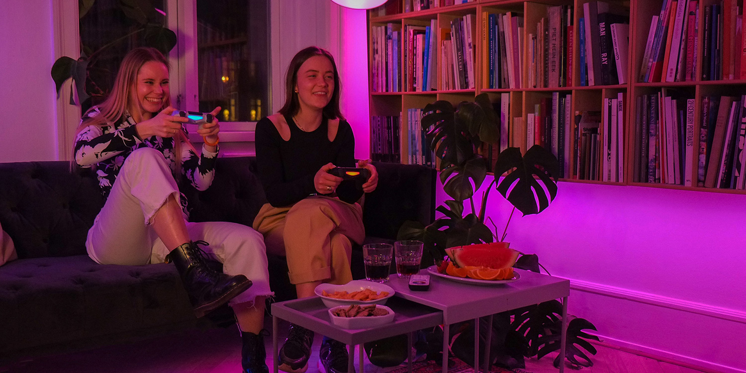 image of two girls playing a video game with synchronized smart lights