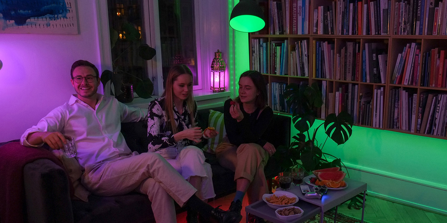 image of people relaxing in a living room in green-coloured light